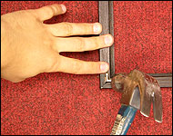 Picture showing how to hammer the fram into place.