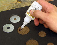 Picture showing how to add glue to the hardboard under the foamcore holes.